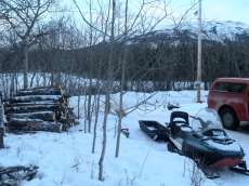 woodpile and snowmobile